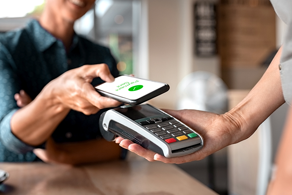 Top tips on contactless retail - Peron paying with smartphone